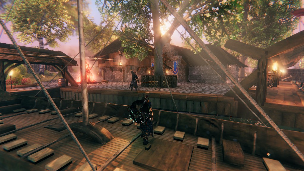 Longship docked at a Viking village at golden hour